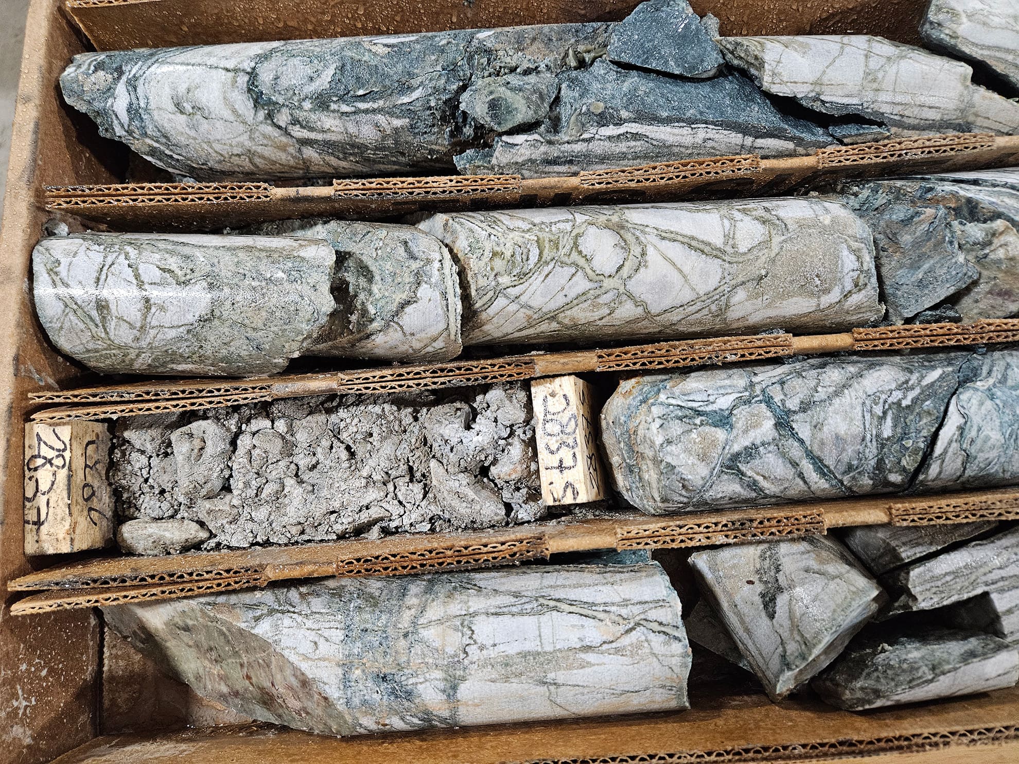 NB26-003; 865 m. The drill hole ended in streaming, high temperature k-spar - clinopyroxene skarn veins in hydrothermally dolomitized wollastonite marble, with coarse molybdenite and chalcopyrite on fracture partings.