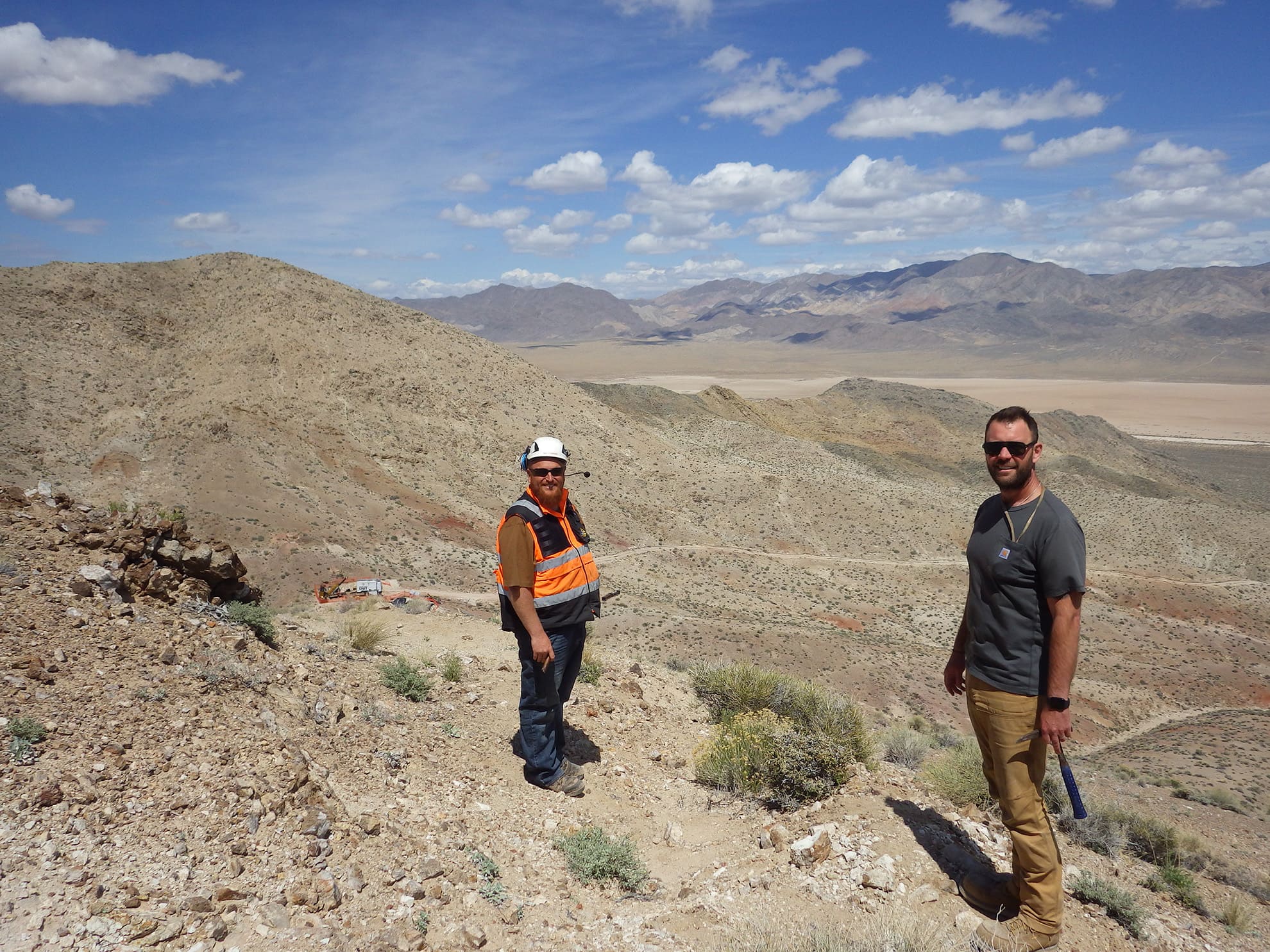 View north at East Zone bowl, with VP Exploration Justin Daley in foreground, drill at drill hole NB24-001 in East Zone bowl in middle ground, and Soda Spring valley and Highway 95 connecting Reno and Vegas’ in background.